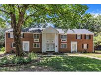 Charming brick multi-Gathering home with lush green lawn and mature trees providing ample shade at 917 Saint Marys St, Raleigh, NC 27605
