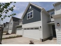 New construction townhome shows siding, garage, front door, and driveway at 919 Montague Ave, Durham, NC 27703