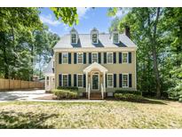 Charming two-story home with dormer windows, blue shutters, complemented by a lush, landscaped front yard at 103 Donna Pl, Cary, NC 27513