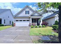 Charming single-Gathering home with a well-manicured lawn and inviting front porch at 1033 Cuthbert Ln, Durham, NC 27703