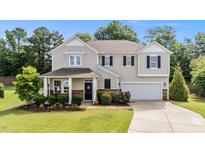 Charming two-story home with a manicured lawn and welcoming front porch, great curb appeal at 108 Yosemite Ct, Holly Springs, NC 27540