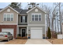 Charming two-story home with grey siding, white garage door and well-maintained landscaping at 1109 Banworth Ct, Mebane, NC 27302