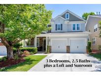 Charming two-story home with a two-car garage, beautiful landscaping, and a welcoming front porch in a residential neighborhood at 1141 Brookhill Way, Cary, NC 27519