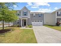 Charming two-story home with a well-manicured lawn and attached two-car garage at 1303 Bent Willow Dr, Durham, NC 27704
