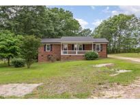 Charming brick home with a welcoming front porch and freshly cut lawn at 2670 Nc 210 S, Lillington, NC 27546