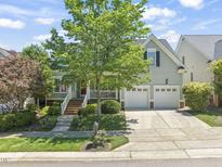 Charming home featuring a two-car garage, landscaped front yard, and inviting front porch, perfect for relaxation at 2720 Snowy Meadow Ct, Raleigh, NC 27614