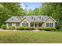 Charming home with manicured lawn and mature landscaping offers great curb appeal at 2917 Kesler Trl, Mebane, NC 27302