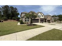 Charming brick home featuring a well-manicured lawn, mature tree, and two-car garage, perfect for suburban living at 3406 Antler View Dr, Apex, NC 27502