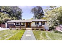 Charming single-story home with a modern black and white exterior and welcoming front porch at 4501 Rockwood Dr, Raleigh, NC 27612