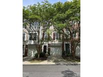 Charming townhome with a well-maintained lawn, garage and mature trees providing shade at 5310 Echo Ridge Rd, Raleigh, NC 27612