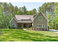 Charming home featuring a well-manicured lawn and inviting front entrance at 59 Mill Rd, Pittsboro, NC 27312