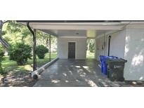 Covered carport featuring brick walls and concrete floor, offering practical parking and shelter at 626 S Hoover Rd, Durham, NC 27703
