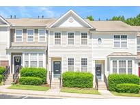 Charming townhome featuring well-maintained landscaping and inviting curb appeal at 7616 Satinwing Ln, Raleigh, NC 27617