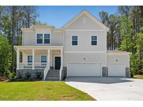 Charming two-story home with a welcoming front porch and a two-car garage at 110 Cribbs Ln, Middlesex, NC 27557