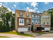 Charming townhomes featuring varied exteriors, attached garages, and beautifully landscaped front yards at 1101 Boxcar Way, Apex, NC 27502