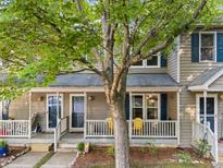 Charming home featuring a covered front porch, blue shutters, and a well-maintained yard at 117 Candace Pl, Cary, NC 27513