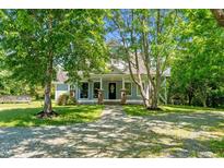 Charming home featuring a welcoming front porch, classic design and beautiful front yard at 1661 Reno Sharps Store Rd, Bear Creek, NC 27207
