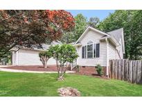 Charming home featuring manicured lawn, mature trees, and classic white siding at 1808 Betry Pl, Raleigh, NC 27603