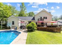 Expansive backyard featuring a well-maintained pool, spacious deck and patio perfect for entertaining at 2113 Port Royal Rd, Raleigh, NC 27609