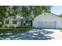 Charming home featuring a two-car garage, classic white siding, and a well-manicured front yard at 2717 Jack Rd, Clayton, NC 27520