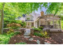 Charming home with a well-manicured front yard and stone walkway leading to a covered porch at 300 Livingstone Dr, Cary, NC 27513