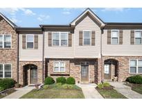 Charming townhome featuring a stone and siding facade, complemented by manicured landscaping and inviting entrances at 3945 Amelia Park Dr, Raleigh, NC 27606