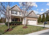 Charming two-story home featuring stone accents, a two-car garage, and a well-maintained front yard at 4 Seawell Ct, Durham, NC 27703