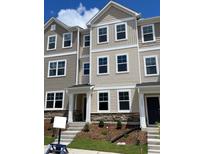 New townhome shows a charming exterior with stone accents and a welcoming entrance at 4002 Silver Oak Ln, Durham, NC 27703