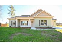Charming one-story home with a well-maintained lawn and inviting entrance at 404 S Eastwood Dr, Benson, NC 27504