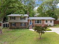Charming two-story home with brick and siding exterior, manicured lawn, and mature trees offering curb appeal at 600 Longleaf Dr, Chapel Hill, NC 27517
