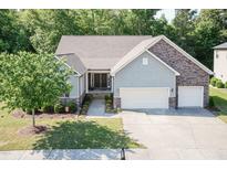 Beautiful two-story home with a two-car garage, stone accents, and a well-manicured lawn at 7660 Channery Way, Raleigh, NC 27616
