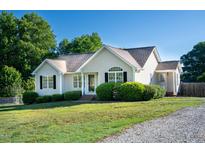 Charming one-story home featuring a well-maintained lawn and manicured landscaping at 78 Cross Creek Ct, Timberlake, NC 27583
