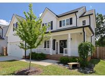 Charming two-story home featuring a welcoming front porch, black shutters, and well-manicured landscaping at 808 Trinity Park Dr, Wake Forest, NC 27587