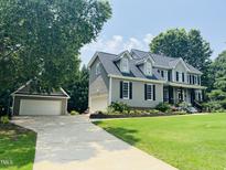 Beautiful two-story home with manicured lawn and separate two car garage at 8517 Falkirk Ridge Ct, Wake Forest, NC 27587