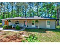 Charming single-story home with a welcoming front porch and well-maintained landscaping at 9220 Old Cascade Dr, Garner, NC 27529