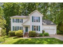 Charming two-story home with a well-manicured lawn and traditional architectural details and a 2 car garage at 9408 Bells Valley Dr, Raleigh, NC 27617