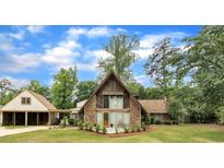 Charming home featuring a stone facade, wooden accents, and a lush green lawn at 1003 W Divine St, Dunn, NC 28334