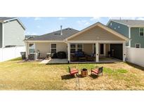 Cozy backyard with covered patio perfect for entertaining or relaxing by the fire pit at 1012 Ringhill Bluff Dr, Durham, NC 27704