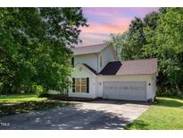 Charming two-story home with a two-car garage and lush greenery in a well-maintained neighborhood at 105 Hiddenwood Ct, Garner, NC 27529