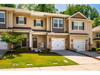 Charming townhome features stone accents, a one-car garage, and inviting curb appeal at 1101 Compass Dr, Durham, NC 27713