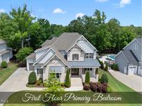 An exterior shot of the two-story home boasting manicured lawn, brickwork, and neutral paint at 1308 Mackinaw Dr, Wake Forest, NC 27587