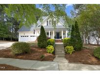 Charming two-story home with manicured front yard and inviting entrance staircase at 1605 Heritage Club Ave, Wake Forest, NC 27587