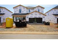New home being built with Tyvek wrap and construction materials on the lot at 2238 Cherry Creek Rd, Haw River, NC 27258