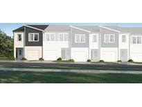 Modern townhome exterior showcasing a sleek design and well-manicured landscaping at 3004 Vitner Dr, Durham, NC 27704
