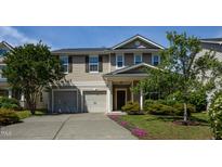 Charming two-story home featuring a two car garage and manicured landscaping at 310 Seymour Pl, Cary, NC 27519