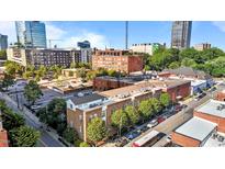 City view showing the building's exterior with surrounding buildings on a clear, sunny day at 320 W Martin St # 205, Raleigh, NC 27601