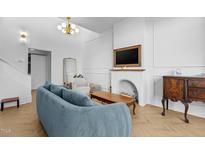 Bright living room featuring herringbone floors, a stylish sofa, and a decorative fireplace at 320 W Martin St # 205, Raleigh, NC 27601