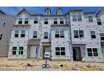 New construction townhome exterior featuring multiple stories and large window openings at 352 Chesapeak Commons St # 136, Garner, NC 27529