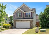 Two-story home with a two-car garage, stone accents, and charming curb appeal at 3566 Sunbright Ln, Raleigh, NC 27610