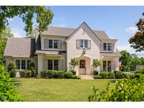 Stunning two-story painted brick home with mature trees, manicured lawn and beautifully trimmed shrubbery at 4404 Yadkin Dr, Raleigh, NC 27609